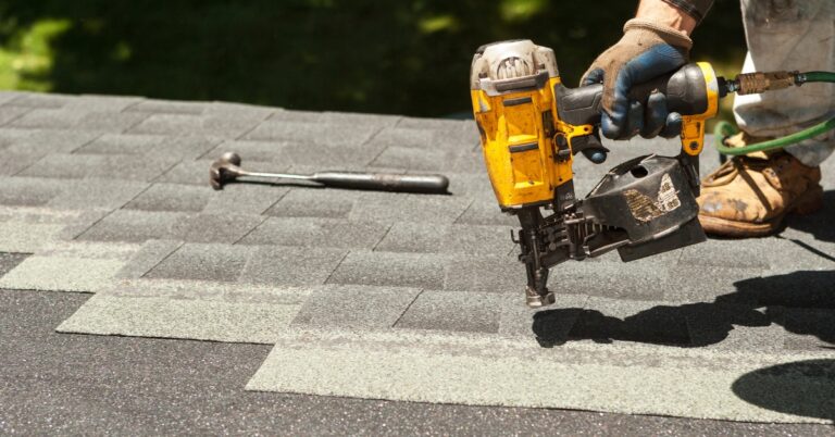 Roofing contractor installing asphalt shingles on a residential home in West Valley City, Utah