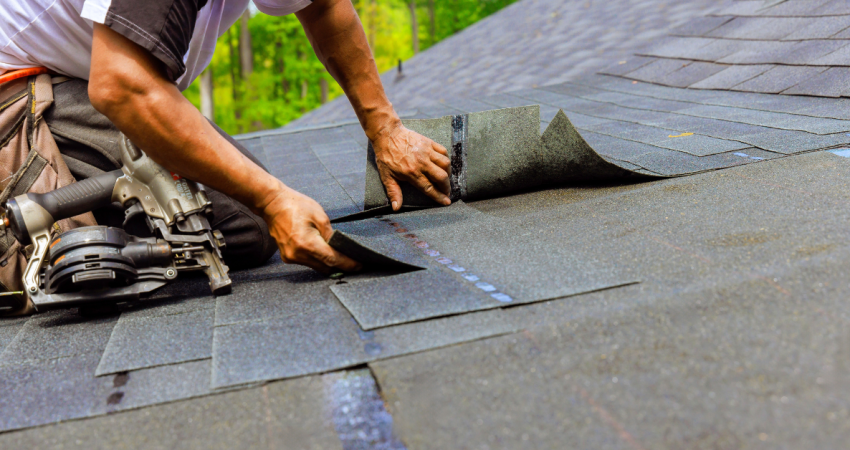 Roofing professionals repairing shingles on a residential home in Utah