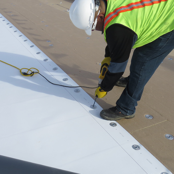Certified roofers installing TPO membrane with heat welder