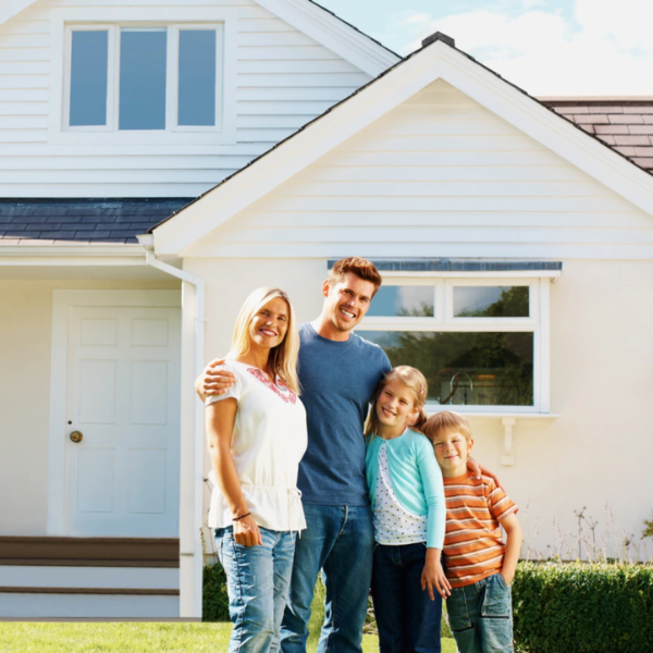 Family standing in front of a Utah home with a newly installed metal roof
