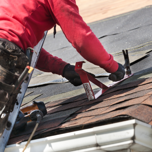 Certified roofer inspecting roof after a leak