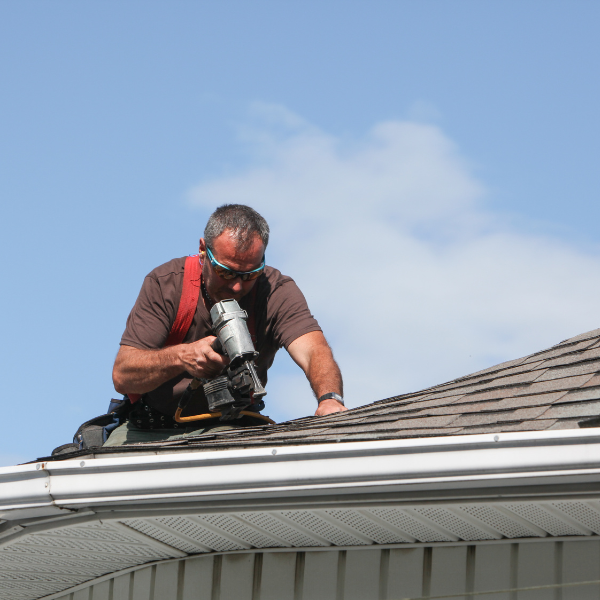 Roofing crew performing repair work on residential home
